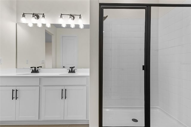 bathroom with a shower with door and vanity