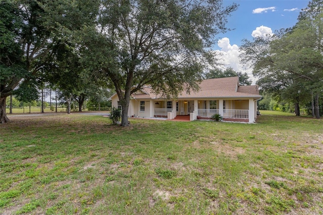 view of front facade featuring a front lawn and covered porch