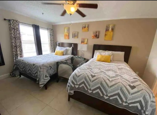 tiled bedroom featuring crown molding, a textured ceiling, and ceiling fan