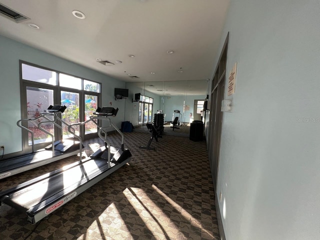 exercise room with dark colored carpet