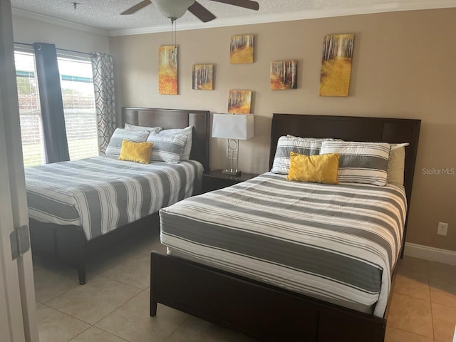 tiled bedroom featuring crown molding, a textured ceiling, and ceiling fan