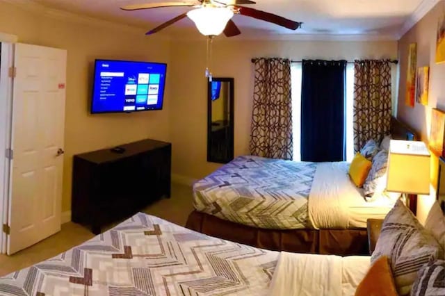 bedroom with ornamental molding and ceiling fan