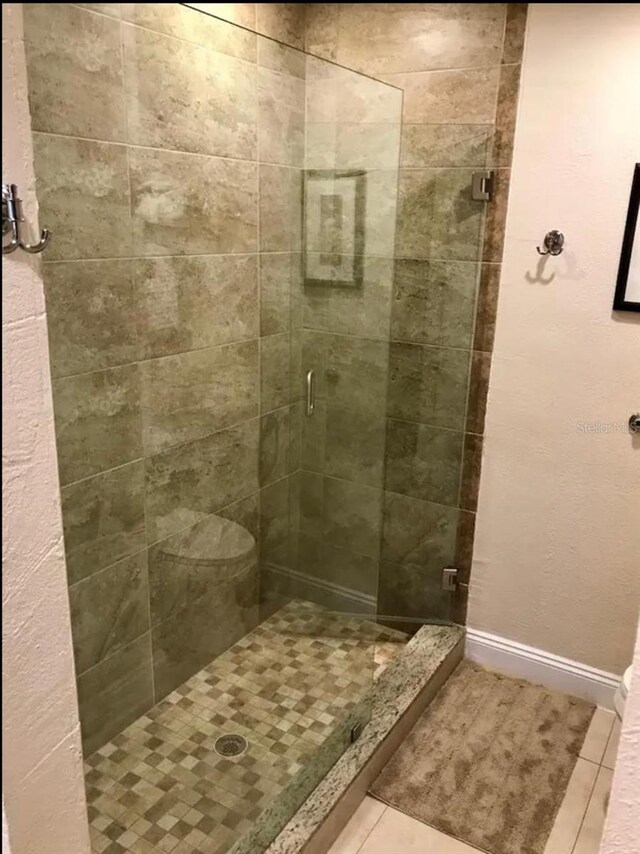 3100 Parkway Blvd Unit 717, Kissimmee, FL 34747 - bathroom featuring a stall shower, tile patterned floors, and baseboards