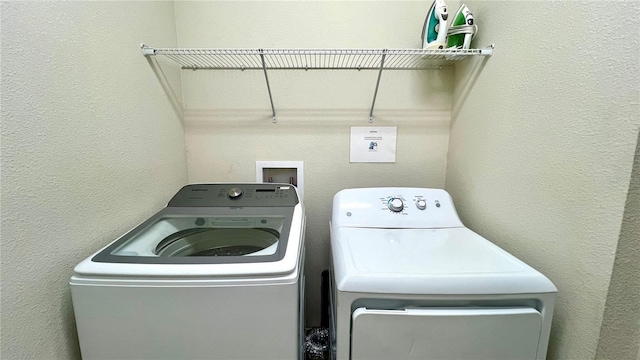 laundry area featuring washing machine and clothes dryer