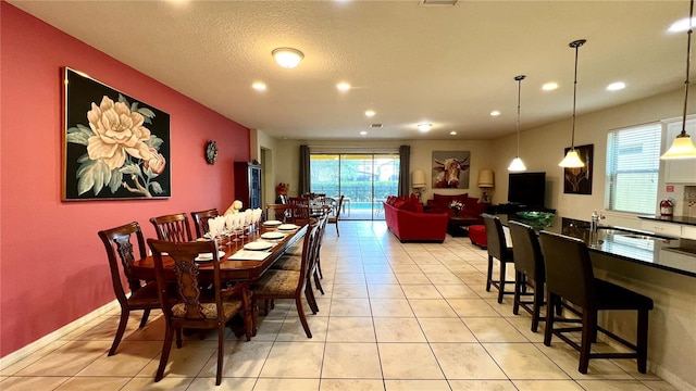 dining space featuring light tile patterned flooring and sink