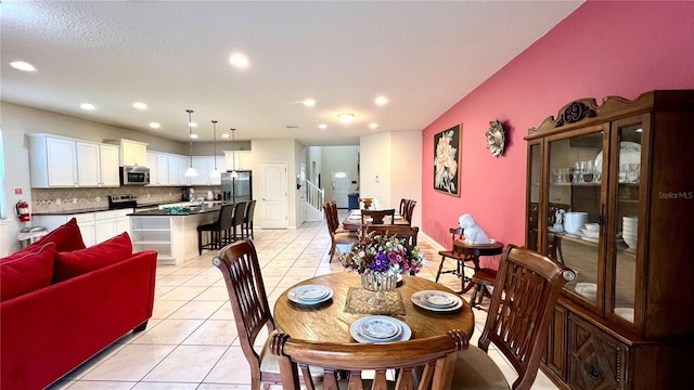 dining area featuring light tile patterned floors