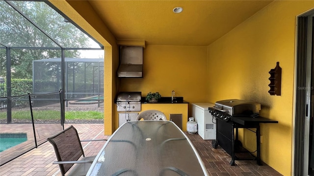 view of patio / terrace featuring area for grilling and glass enclosure