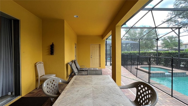 view of patio featuring a lanai and a pool with hot tub