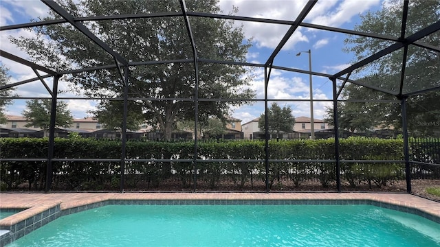 view of swimming pool with glass enclosure