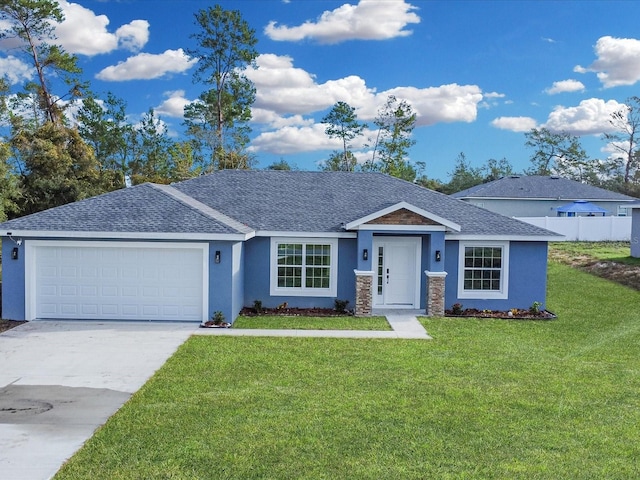 view of front facade with a front yard and a garage