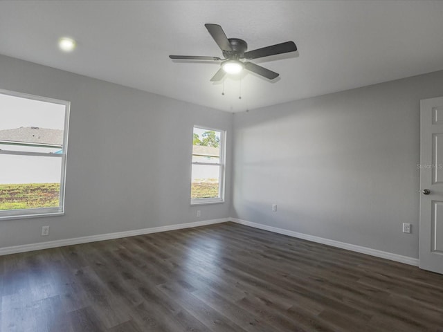 spare room featuring dark wood-type flooring and ceiling fan