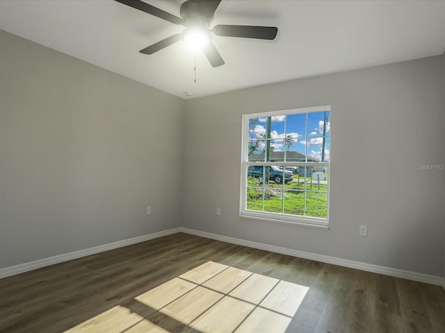 unfurnished room with dark hardwood / wood-style floors and ceiling fan