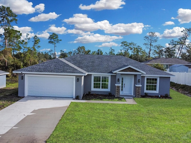 view of front facade featuring a front yard and a garage