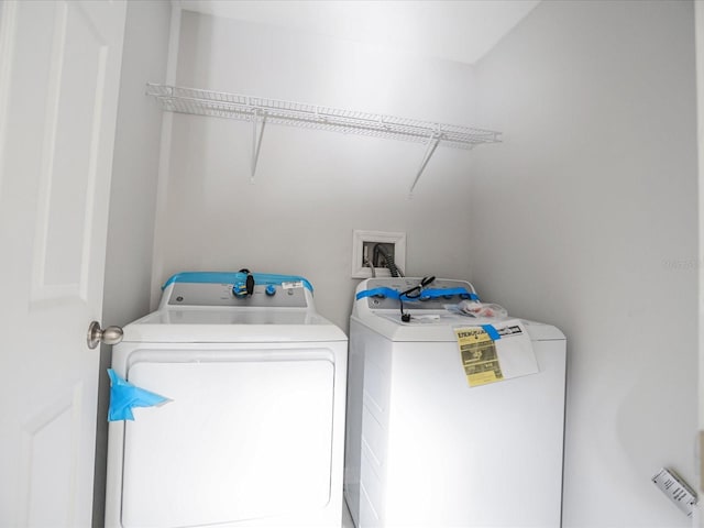 laundry room featuring washing machine and clothes dryer