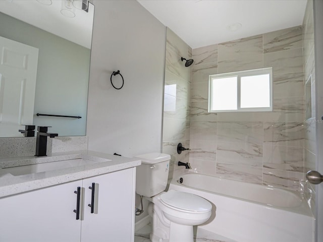 full bathroom featuring toilet, tiled shower / bath, and vanity