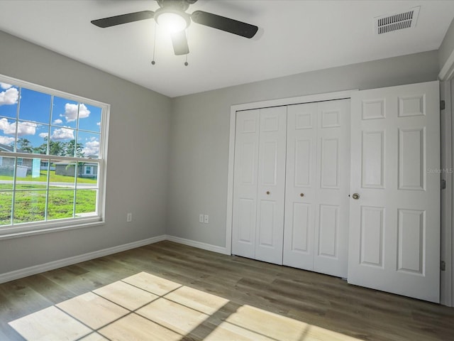 unfurnished bedroom featuring light hardwood / wood-style flooring, a closet, and ceiling fan