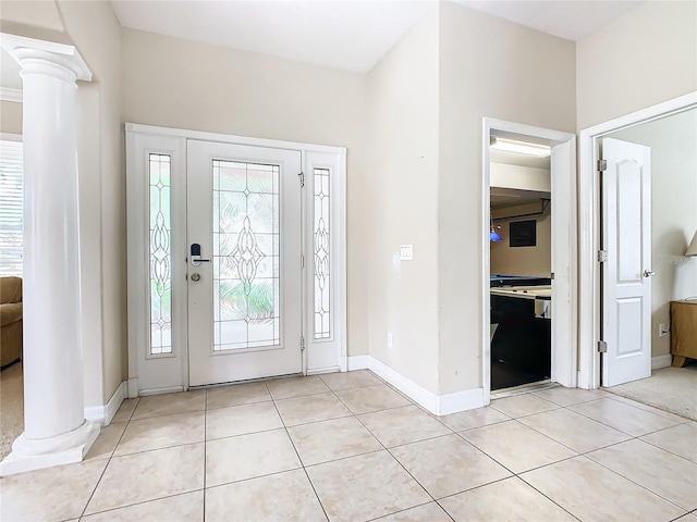 tiled foyer featuring ornate columns