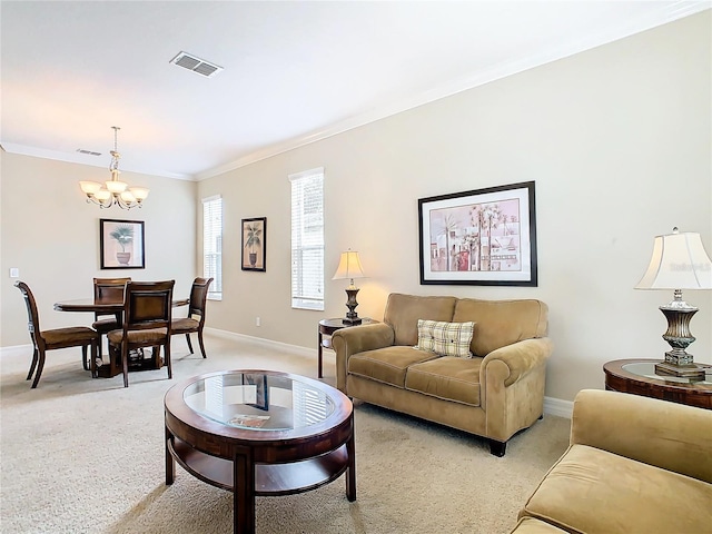 carpeted living room featuring ornamental molding and a chandelier