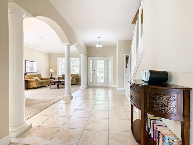 carpeted foyer featuring ornamental molding