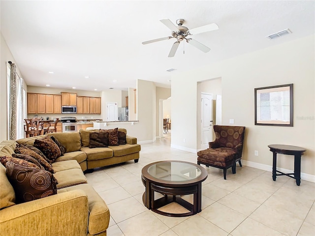 living room with light tile patterned floors and ceiling fan