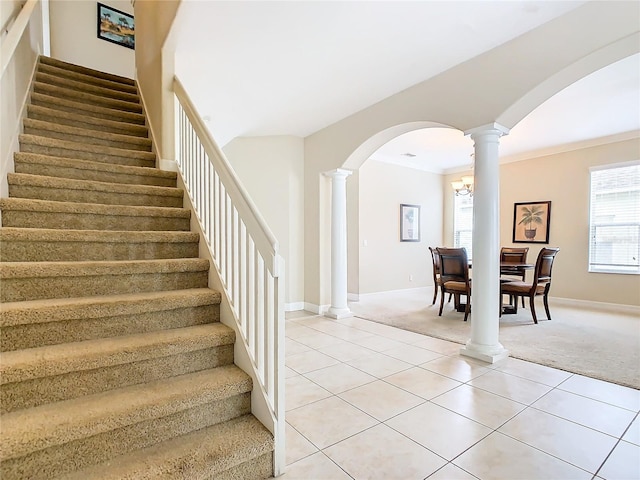 stairs featuring a notable chandelier, carpet, and ornamental molding