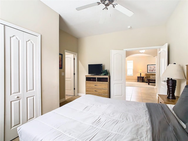 tiled bedroom featuring a closet and ceiling fan