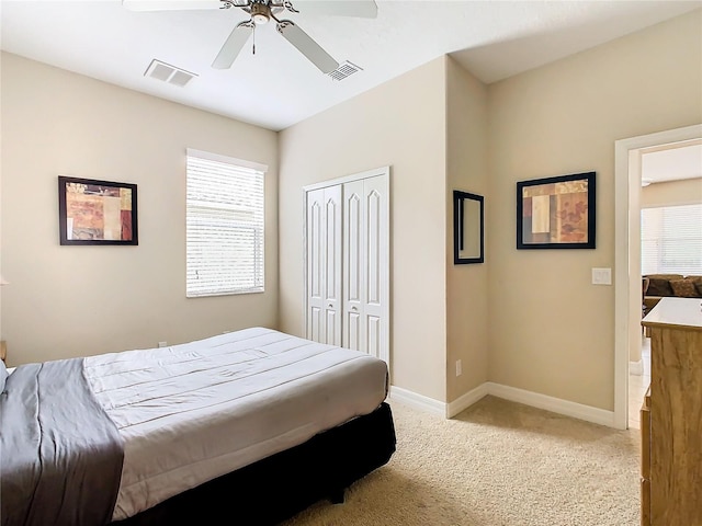 carpeted bedroom with a closet and ceiling fan