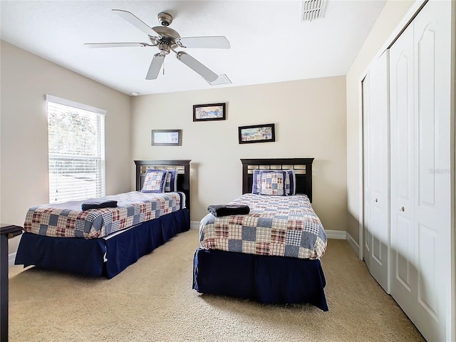 carpeted bedroom featuring a closet and ceiling fan