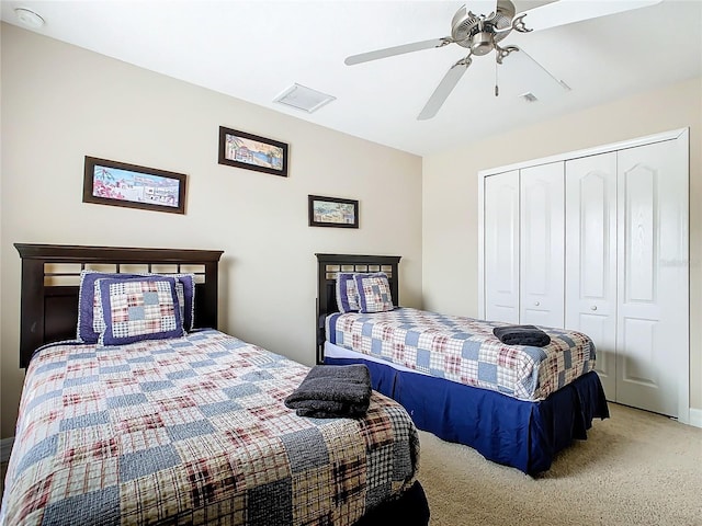 carpeted bedroom featuring a closet and ceiling fan