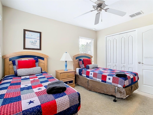 bedroom with a closet, carpet floors, and ceiling fan