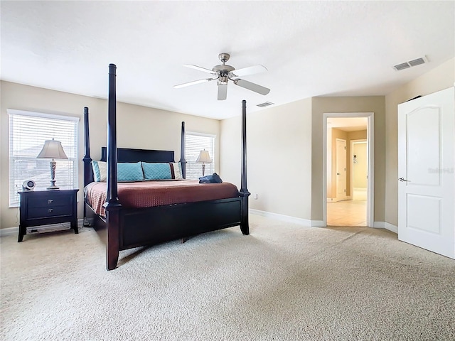 bedroom featuring light colored carpet and ceiling fan