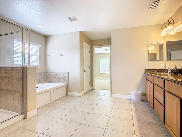 bathroom featuring vanity, a textured ceiling, tile patterned floors, and independent shower and bath