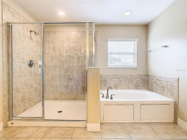 bathroom featuring tile patterned floors and shower with separate bathtub