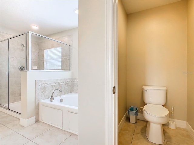 bathroom featuring toilet, plus walk in shower, and tile patterned floors