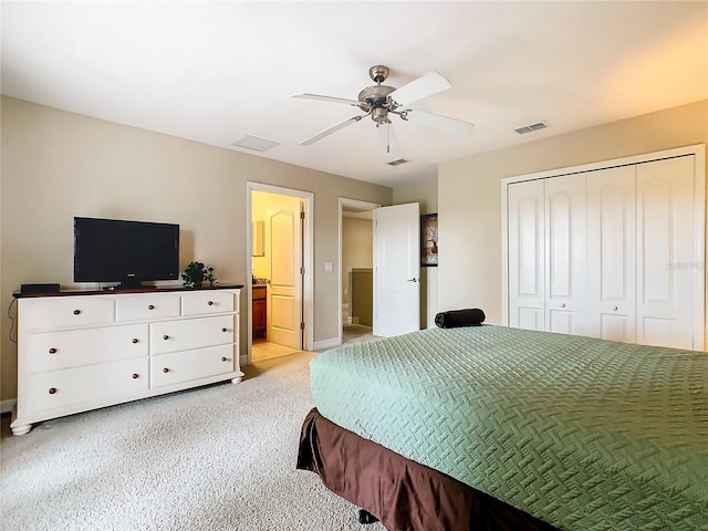 carpeted bedroom featuring ensuite bathroom, a closet, and ceiling fan