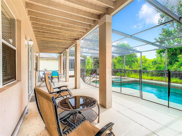 view of patio featuring a lanai