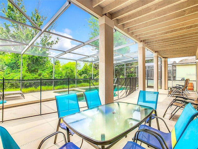 view of patio featuring glass enclosure