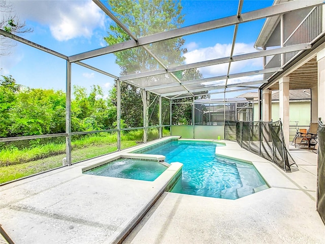 view of swimming pool with a patio area, a lanai, and an in ground hot tub