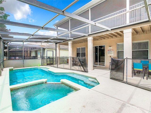 view of swimming pool with a patio area and a lanai