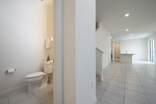 bathroom featuring tile patterned floors, toilet, and sink