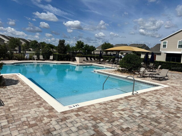 view of swimming pool with a patio area