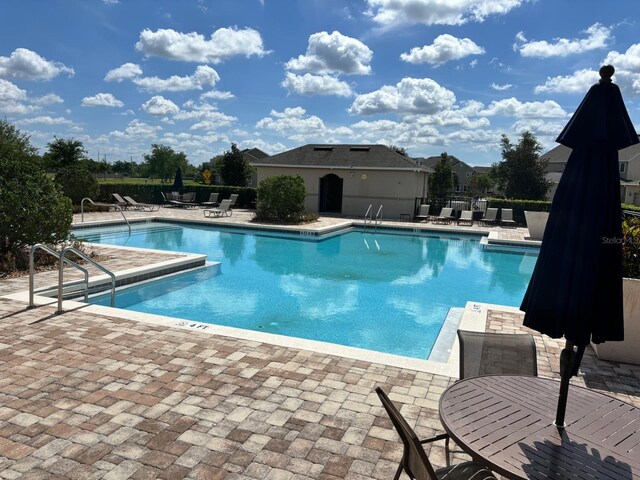 view of swimming pool with a patio area