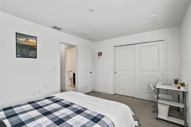 carpeted bedroom with visible vents and a closet