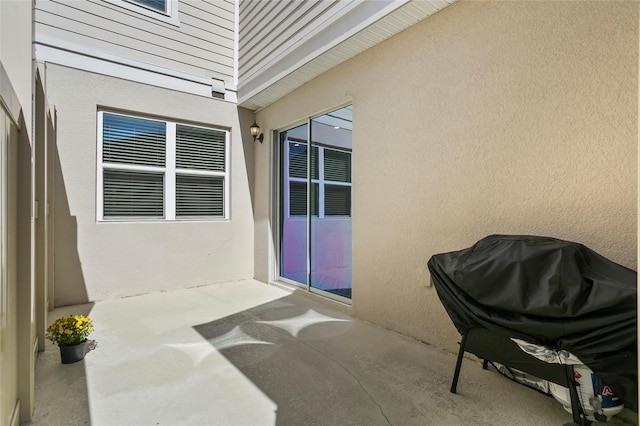 property entrance featuring a patio area and stucco siding