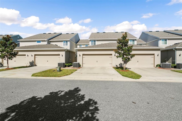 view of front of house featuring driveway and central AC