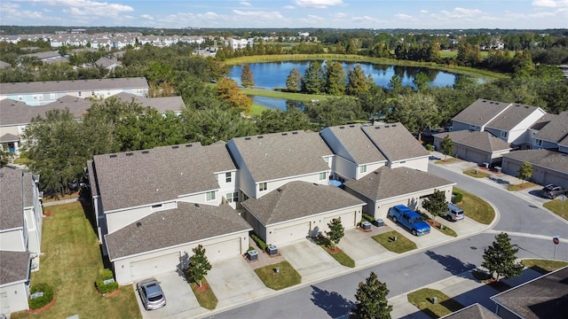 drone / aerial view featuring a residential view and a water view