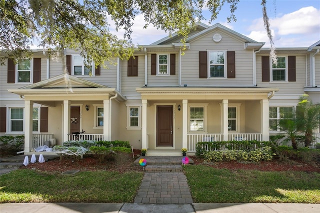multi unit property featuring a porch and stucco siding