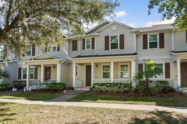 townhome / multi-family property with a porch