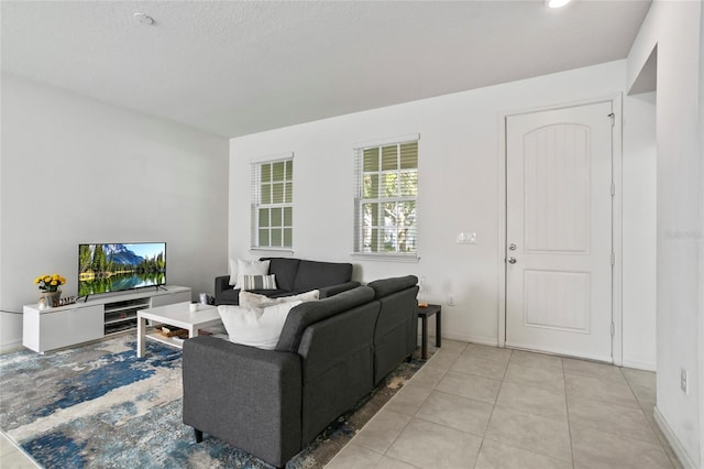 living area with light tile patterned floors and baseboards