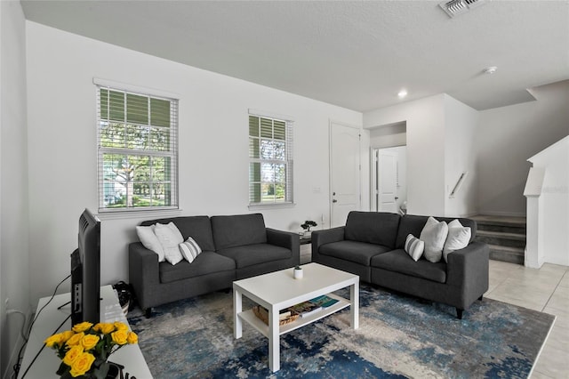 tiled living room featuring stairway, recessed lighting, and visible vents
